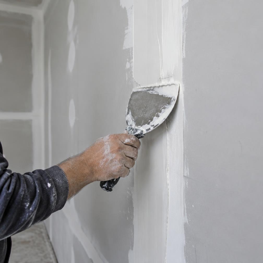 Illustrative close-up of drywall joint finishing